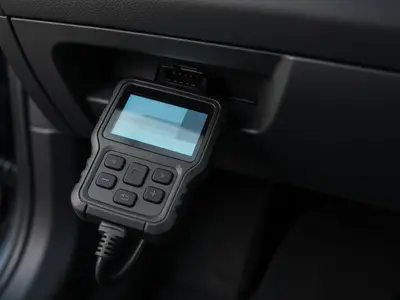 Key programming tool plugged into a car